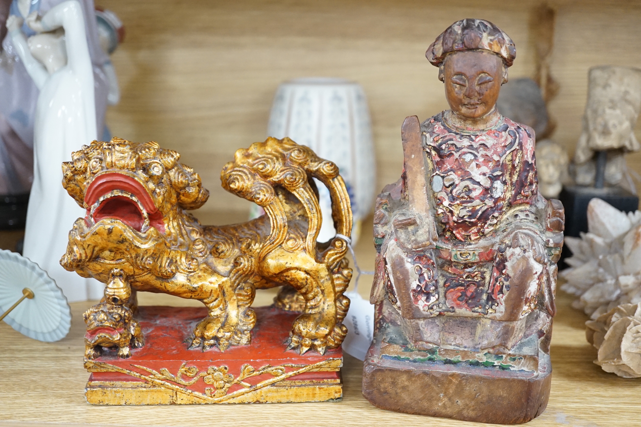 A Chinese lacquered wood figure of a seated woman and a Buddhist lion, tallest 20.5cm